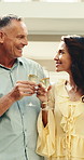Couple, cheers and smile with champagne in resort, anniversary and bonding with partner on vacation. Hotel, romance and happy people with alcohol on holiday, toast and celebration on special day