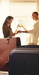Luggage, couple and dance in hotel with vacation, love and bonding together for anniversary getaway. Travel bags, happy people and movement in lodge with music, romantic relationship and holiday.