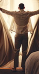 Back, man and open curtains in hotel with morning routine, relax and thinking with peaceful vacation. Person, start day and reflection by accommodation window with drapes, holiday and rest on trip.