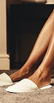 Morning, woman or legs in hotel with slippers, wake up or comfortable for luxury vacation on weekend. Person, start day and holiday in accommodation with plush shoes, peace and relax for getaway.