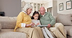 Grandparents, education and child with tablet in home, talk or senior people with skill development. Digital literacy, knowledge and family with technology, elearning and bonding with girl in lounge