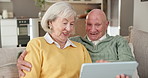 Tablet, home and senior couple talking on living room sofa for internet connection, app or search. Happy old man, woman and laugh with technology for online news, retirement or choice of ebook