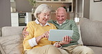 Tablet, home and senior couple with internet connection on living room sofa for joke, app or search. Happy old man, woman and laugh with technology for online game, retirement or choice of ebook