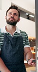 Owner, man and open door at cafe with thinking, start day and contemplation for hospitality service. Manager, person and ready at coffee shop entrance with welcome, reflection and small business.
