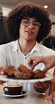 Cafe, man and eating cake with friends for breakfast, taste test or clap for new flavor approval. Happy people, hungry or dessert serving at coffee shop to share chocolate treat, applause or feedback