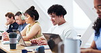 Smile, man and student in classroom with laptop, online research and college lesson for knowledge. Happy, people and typing at campus with pc, scholarship update and study agenda for education video