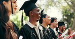 Happy, man and students with diploma at graduation, speech and celebration of degree completion. People, applause and graduate outdoor with regalia, university recognition and educational milestone