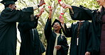 Excited, students and diploma at campus for graduation, farewell or celebrate of degree completion. People, tossing and graduate outdoor with regalia, university achievement and educational milestone