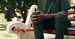 Hands, person and nurse with knee pain on park bench, injury and tendinitis at college campus. Healthcare discomfort, sore leg and medical student outdoor with arthritis, fibromyalgia or strain