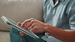Hands, tablet and man in home with internet, online scroll and UX with app for connection on couch. Person, technology and search website, blog or connectivity with network and software interface