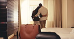 Couple, window and hotel with hug in bedroom for holiday getaway, travel or honeymoon trip together. Back view, man and woman with embrace, love or luggage for weekend stay, accommodation or vacation