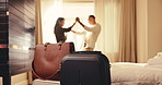 Couple, hotel and dancing with luggage in bedroom for holiday getaway, travel or honeymoon together. Man, woman or movement with love for romantic weekend stay, accommodation or vacation in resort