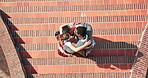 Above, hug and teamwork in synergy or huddle for university education or study with friends. Group of people, connection and collaboration with students for campus community, motivation and support