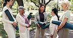 Relax, coach or laugh at park with yoga class, exercise cool down or joke for healthy aging. Mat, happy mature women and yogi instructor with water break, funny workout rest and post fitness session