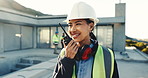 Woman, radio and communication on construction site with smile, quality assurance and project. Contractor, female person and conversation with tech for engineer, planning and safety compliance