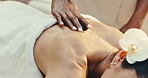 Spa, back massage and woman with hot stones for wellness, muscle tension or stress relief at resort. Hospitality, person and masseuse with heat therapy for holistic healing, treatment and self care