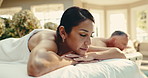 Spa, relax, and couple on bed for massage with physical therapy, smile or luxury treatment at resort. Hotel, hospitality and mature people for stress relief, muscle reflexology or holistic detox