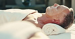 Spa, relax and man with face mask for facial, wellness and skincare treatment at luxury resort. Hospitality, pamper and mature person with calm for dermatology, detox and self care for skin hydration