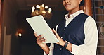 Woman, receptionist and hands with tablet at front door for hotel, travel or booking accommodation. Lobby, concierge and digital tech for guest, reservation and customer service for hospitality