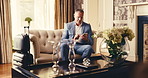 Hotel, lounge and businessman with phone, typing and relax at reception on business trip. Hospitality, travel accommodation and mature person in lobby with digital tech, luggage and online check in
