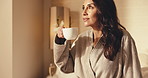 Thinking, smile or woman in hotel room with coffee, trip reflection or calm moment on holiday break. Chill, tourist or mature person with warm drink, peaceful perspective or mindfulness on vacation.