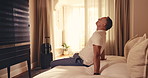 Luggage, man and arrival in hotel room with relax, overnight stay and unwind for business travel. Suitcase, mature professional or smile on bed for work trip checkin, traveler downtime or hospitality