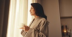 Thinking, coffee or woman in hotel room with window, trip reflection or calm moment on holiday break. Smile, chill or mature person with warm beverage, peaceful perspective or mindfulness on vacation