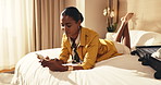 Bed, woman and relax in hotel room with phone, check itinerary or browsing social media for vacation. Person, typing and chill in accommodation with tech, text message or online research for holiday.
