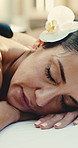 Woman, relax and sleeping at spa with hot stone, massage and treatment for muscle tension. Mature person, flower or aromatherapy at salon with warm rocks, pain relief and thermal therapy for wellness