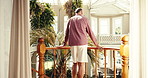 Back, man and balcony at holiday house for weekend break, luxury retirement or travel adventure. Terrace, mature person or relax at lodge for vacation getaway, resort accommodation and hospitality