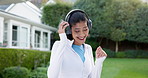 Woman, listening and headphones with music in park for song app, outdoor energy or vibe in nature. Active, female person or dancing with smile, phone sound or audio streaming subscription for podcast