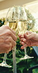 Couple, cheers and hands with champagne in resort, anniversary and bonding with partner on vacation. Hotel, relationship loyalty and people with alcohol on holiday, toast and romance on special day
