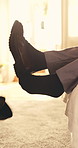 Man, feet and kick off shoes in hotel room with business trip, fatigue and comfortable after work. Person, legs and footwear removal in accommodation with stress relief, unwind and relax after job.