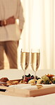 Couple, anniversary and breakfast with champagne in hotel, love and relationship loyalty on holiday. Marriage, commitment and people on special day, healthy food and alcohol for date on vacation