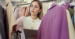Clothes, tablet and woman in retail store for fashion industry, color and rail in boutique. Online shop, inventory and person on app for pricing, sale and discount or trade in casual style stock