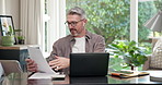 Video call, paperwork and man with laptop in home office, remote work and online coach with advice. Freelance, business advisor and mature person with earphones, report and virtual meeting with tech