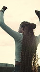 Runner, woman and arms up in city with celebration, applause and happy for fitness goals achievement. Low angle, excited black person and clap outdoor in urban town, exercise or sports accomplishment