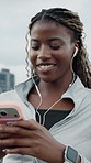 Fitness, phone or happy woman with earphones in city on break, browsing playlist or streaming radio. Mobile, sports podcast or black person with music outdoor, smile or thinking of audio on internet