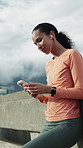 Runner, phone or happy woman with music in city on break, browsing playlist or streaming radio. Mobile, fitness podcast or female person with earphones outdoor, smile and rest with online audio