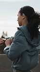 Fitness, woman and running in city with time for cardio endurance, workout practice or track pace. Jog, female person and runner check watch for exercise progress, training and health stats outdoor