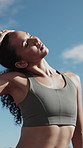 Woman, stretching and exercise in city with fitness, outdoor and athlete getting ready for training. Low angle, runner and person in urban town with warm up, roll shoulders and prepare for workout.
