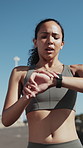 Fitness, tired and runner outdoor with smart watch, training track and break in cardio practice. Exercise, athlete and woman in city with tech, progress monitoring or recovery with performance update
