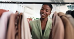 Boutique, choice or woman at clothes rack for shopping, outfit search or sale on garment collection. Happy, black person and browse rail for fashion promotion, apparel outlet or decision for purchase