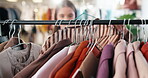 Boutique, decision and woman at clothes rack for shopping, outfit search or garment option on sale. Hanger, customer or browsing rail in store for fashion choice, retail promotion and wardrobe update