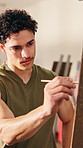 Man, artist and painting in workshop with canvas, drawing and art portfolio for gallery showcase. Smile, male painter and admiration in creative studio with paint brush, artistic process and artwork