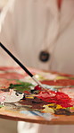 Person, brush and mix paint with palette to create different color, DIY project and design process. Painter, tray and artist blend pigment with tools, creative skills and preparation for art hobby.