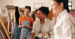 People, teacher and canvas in class for painting, guidance and demonstration for creative artwork. Smile, women and instructor in workshop with paint palette, art lesson and beginner advice for craft
