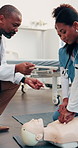 Doctor, dummy and women at hospital for cpr, demonstration and medical course for critical care. Teacher, supervision and nurses in clinic with mannequin, training students and resuscitation process