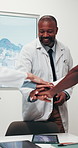 Doctor, man and meeting with hands together in office for collaboration, unity or solidarity. Male person, group or medical team piling with stack in huddle for support, mission or trust in workplace