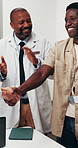 Men, doctor and meeting with handshake for agreement, teamwork or partnership together in hospital. Male people, healthcare workers or shaking hands with smile or applause for medical deal in clinic